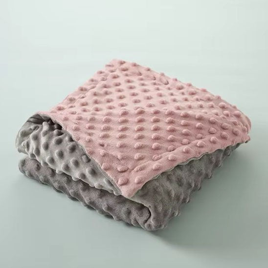 couverture bebe polaire rose et grise texture douce pliee
